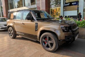 a gold and black land rover defender