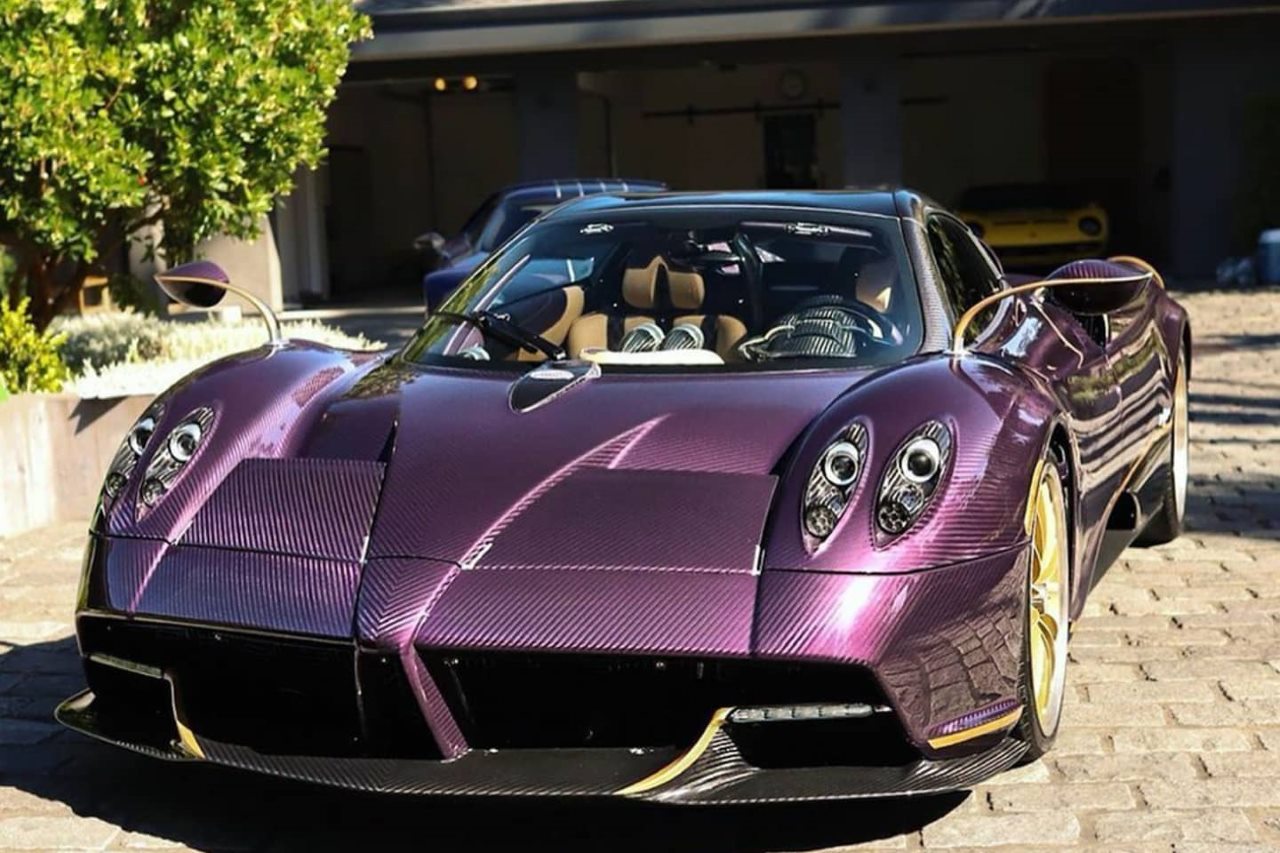 a pagani huayra roadster with a purple carbon fiber exterior