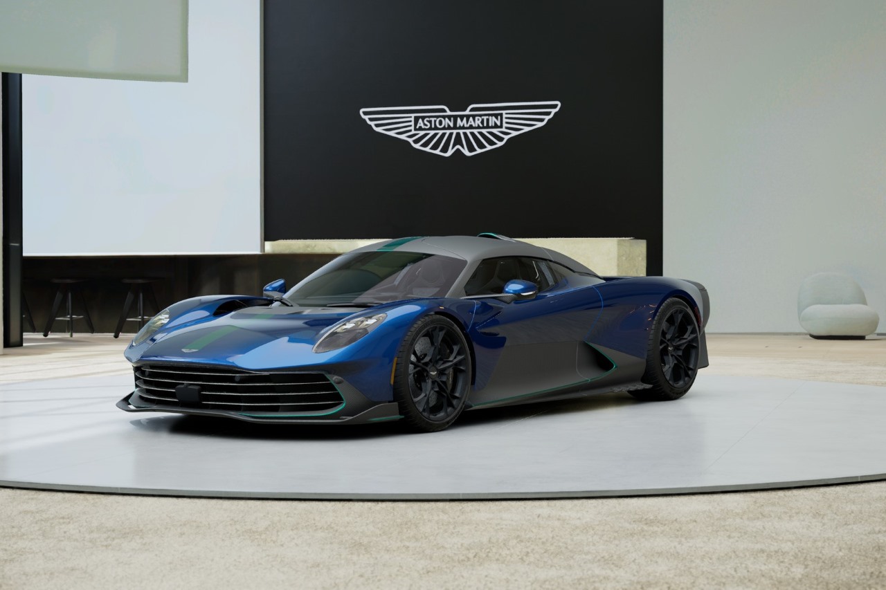 A dark blue Aston Martin Valhalla with teal stripes and accents