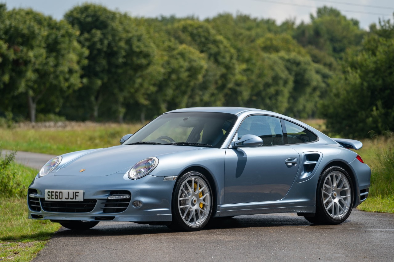 A Porsche 977 Turbo S in an icy blue color