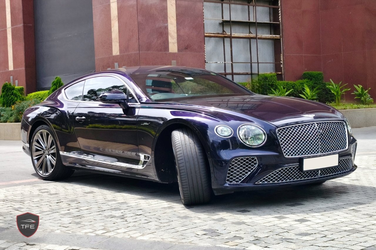 a dark blue Bentley Continental GT Speed from 2024