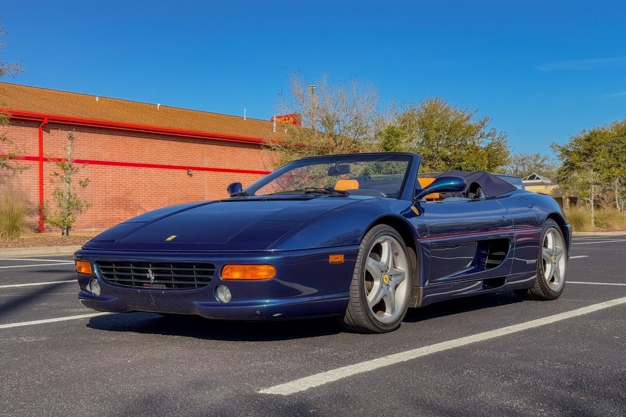 a Ferrari F355 Spider with the top down in the shade of Blu NART