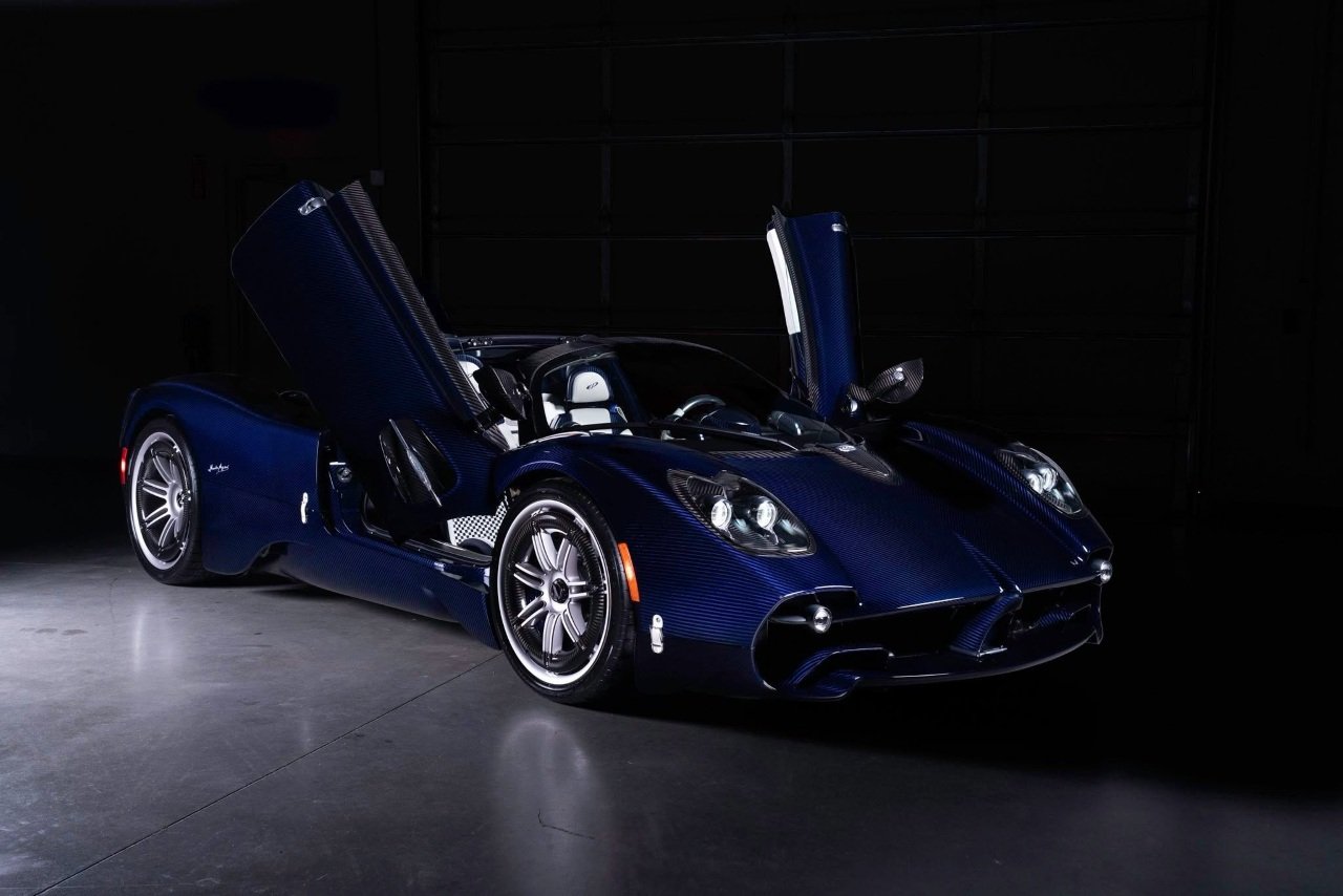 a Pagani Utopia Roadster in Blu Indaco Carbon Fiber with white wheels and interior